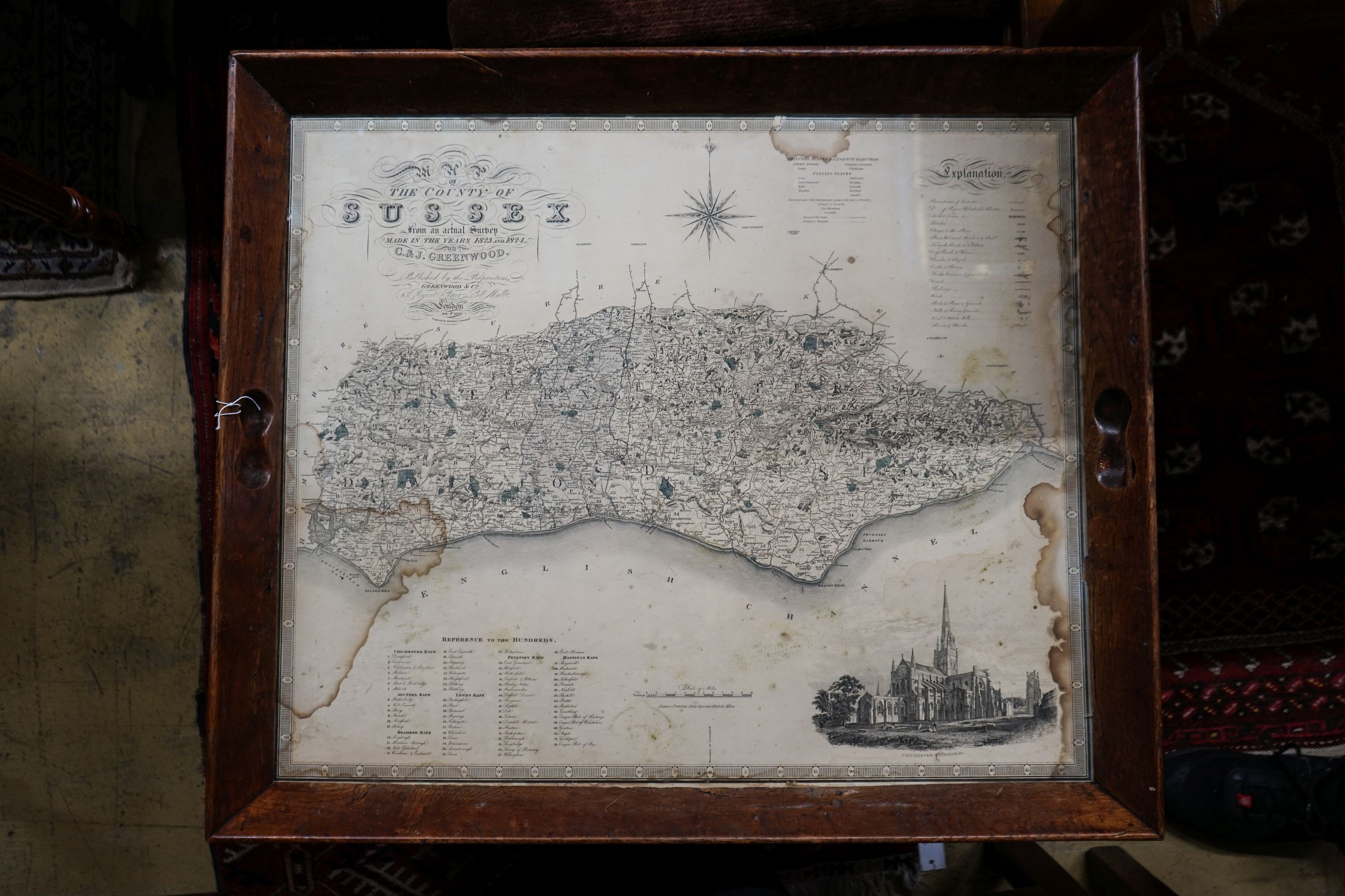 A rectangular oak tray top low table inset with a map of Sussex on ball and claw stand, width 81cm, depth 70cm, height 47cm